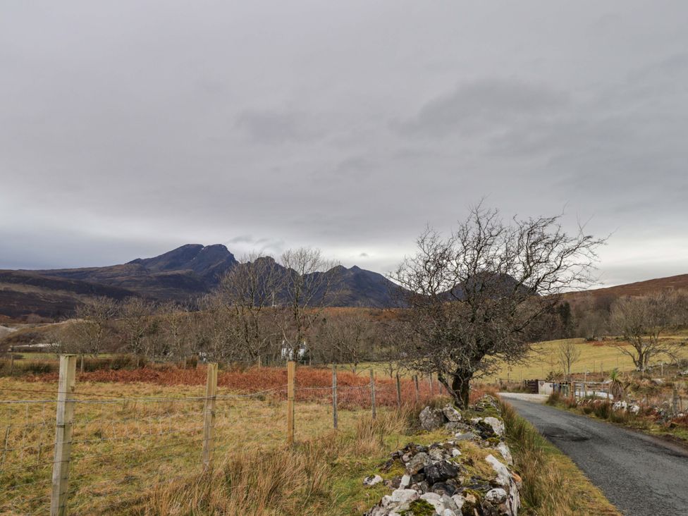 A landscape featuring mountains, a tree, and a road at The Pod at Greenbank Isle of Skye