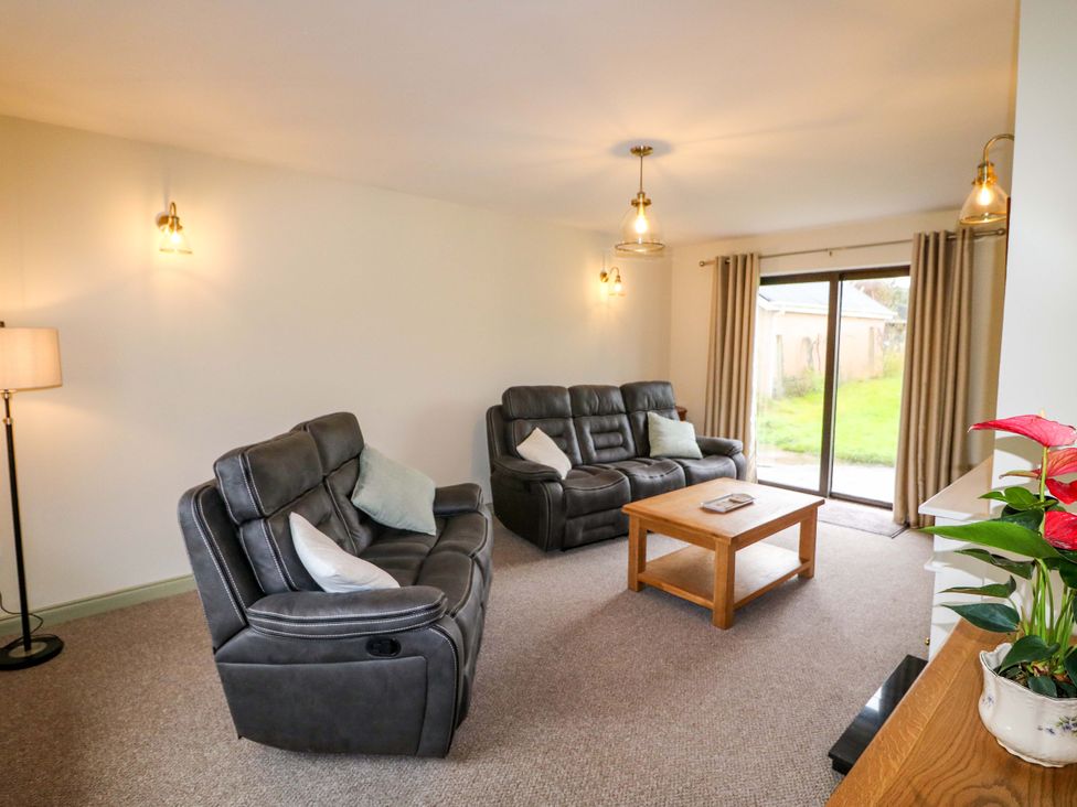 A living room with reclining chairs and a coffee table at Shamrock House
