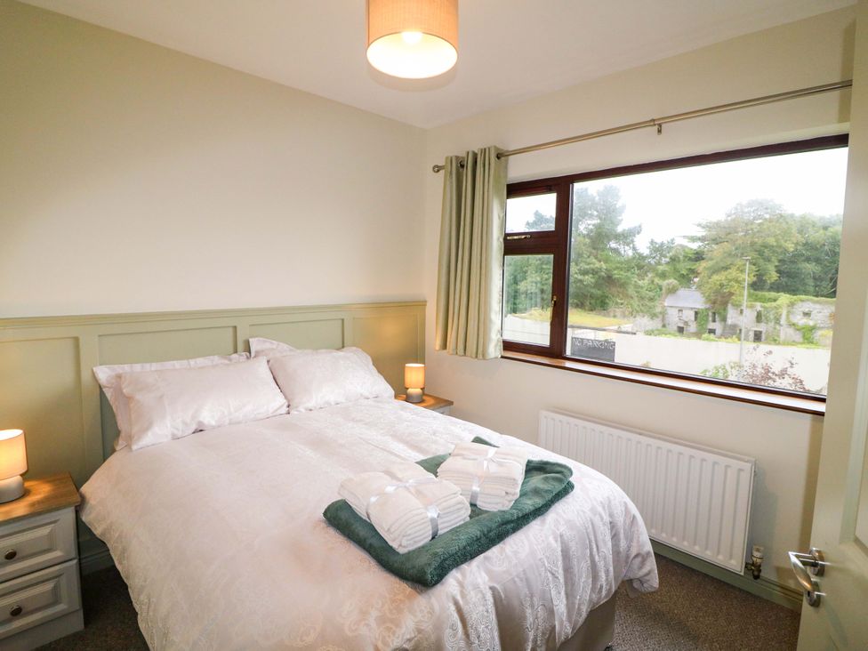A bedroom with a bed and window at Shamrock House