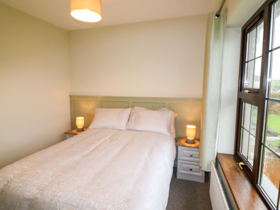 A bedroom with a bed and bedside tables at Shamrock House