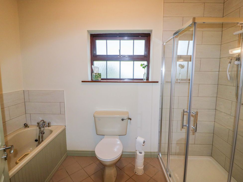 A bathroom with a bathtub and shower at Shamrock House