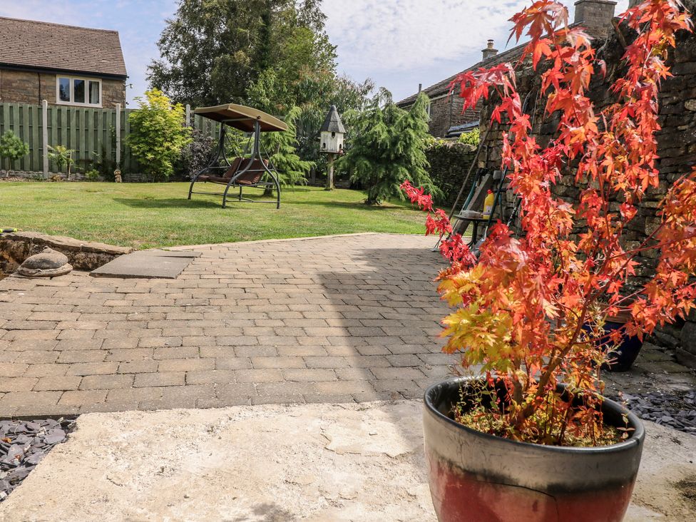 A garden with a potted plant and seating area at Wigley House Farm Bungalow in Chesterfield