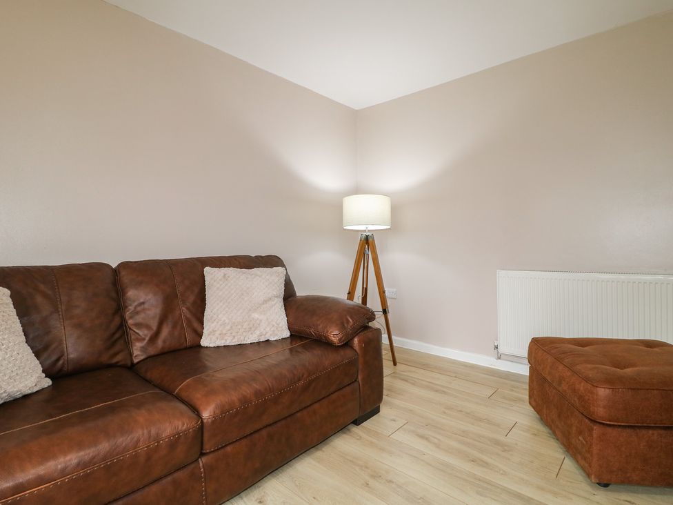 A living room with a sofa and lamp at Wigley Farm House Cottage Chesterfield