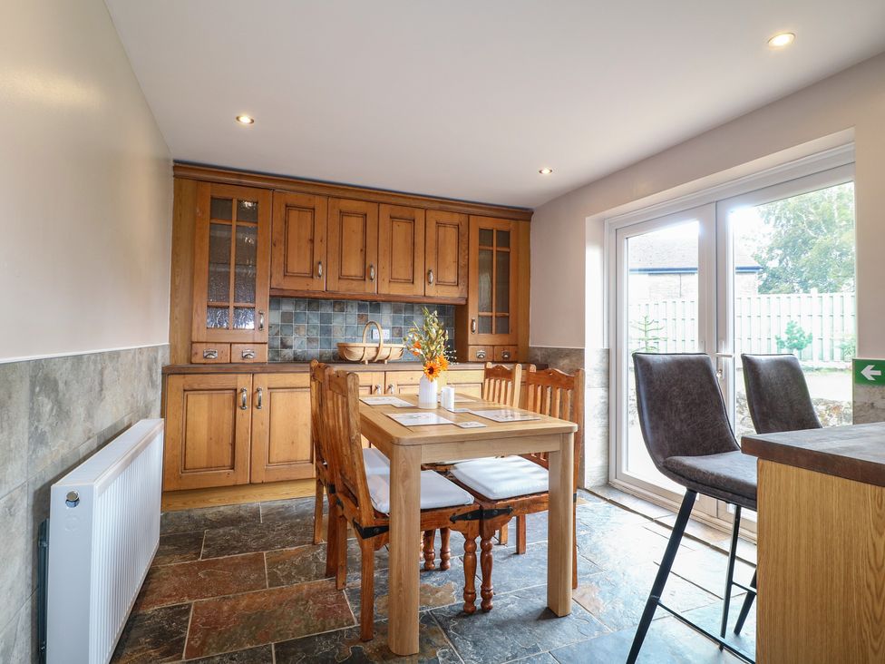 A kitchen with a table and chairs at Wigley Farm House Cottage Chesterfield