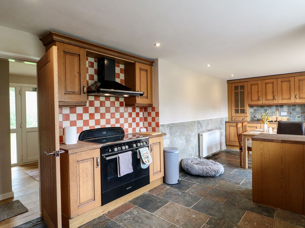 A kitchen with a stove and cabinets at Wigley Farm House Cottage Chesterfield