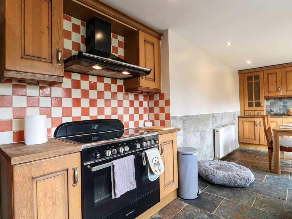 A kitchen with an oven and cupboards at Wigley Farm House Cottage Chesterfield