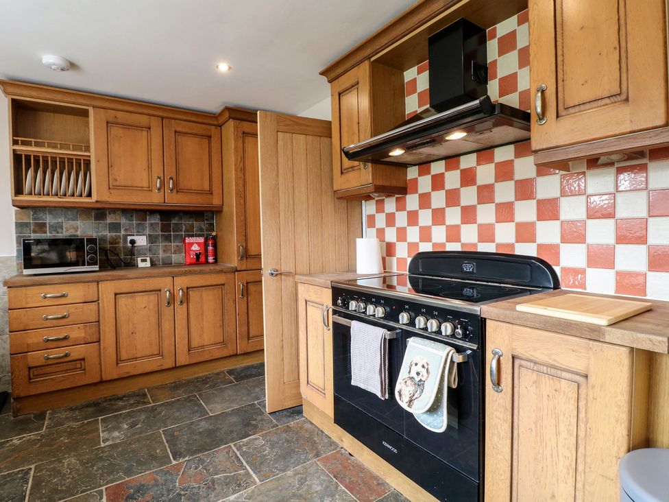 A kitchen with cabinets and an oven at Wigley Farm House Cottage Chesterfield