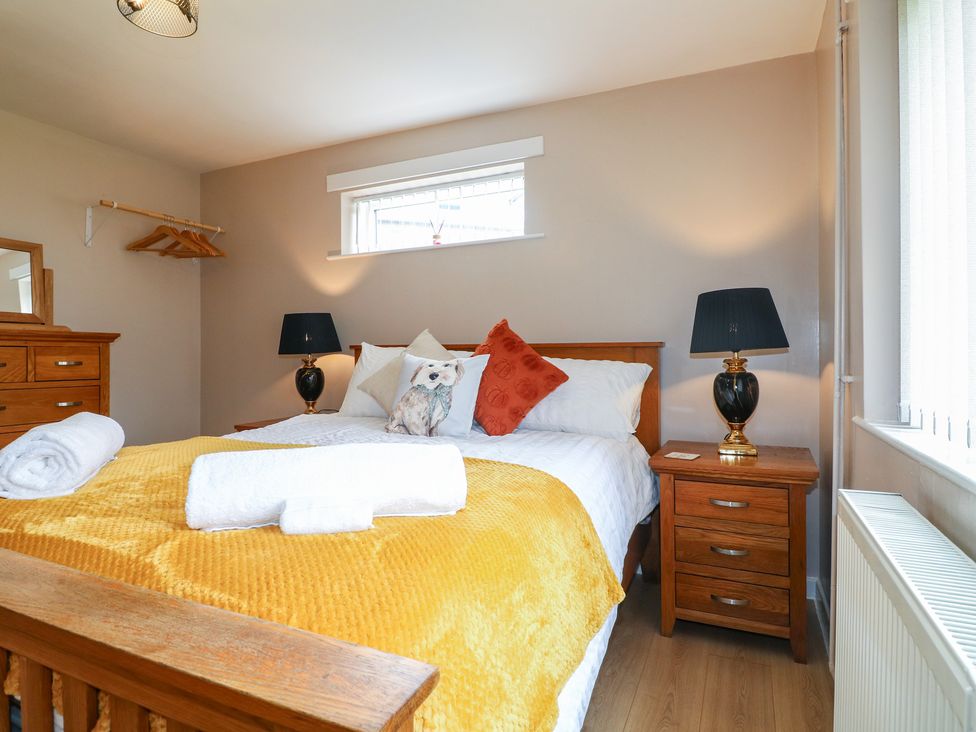 A bedroom with a bed and dresser at Wigley Farm House Cottage in Chesterfield