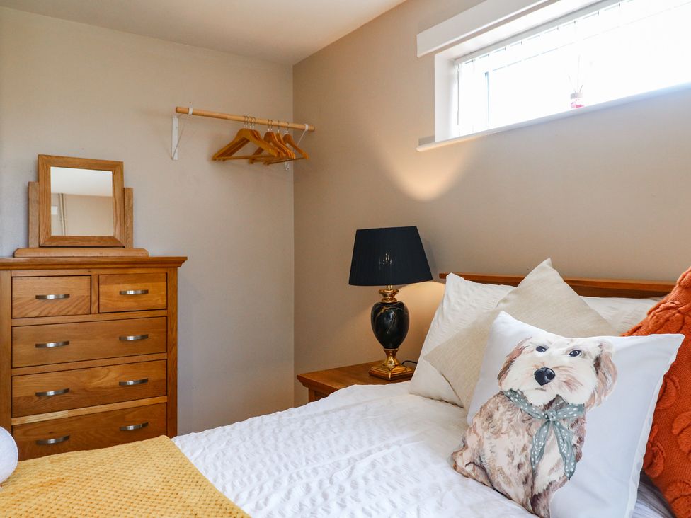 A bedroom with a bed and dresser at Wigley Farm House Cottage Chesterfield
