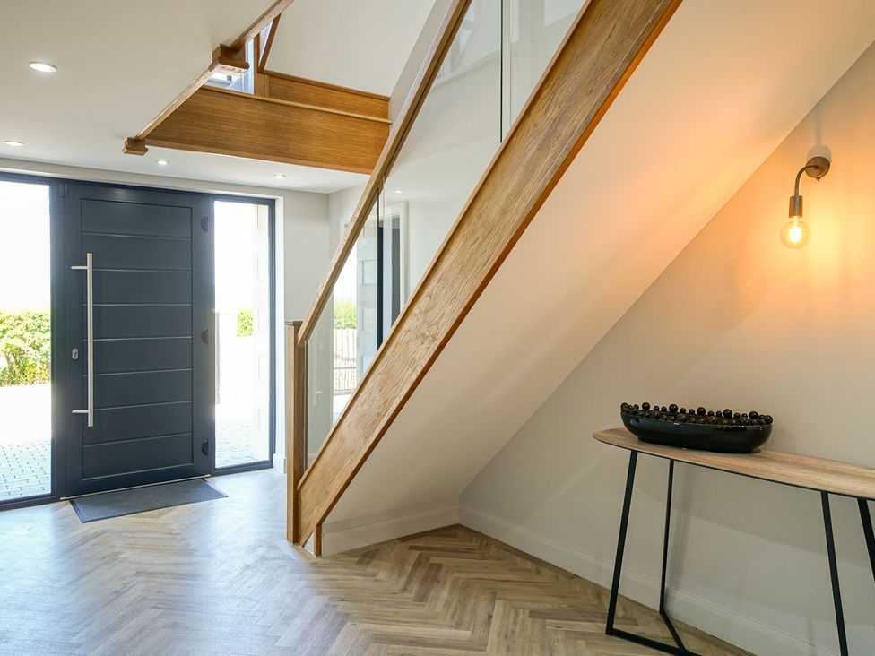 An entrance hall with a staircase and a front door at Northstone House Blackburn