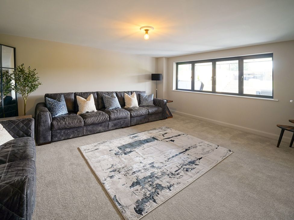 A living room with a sofa and rug at Northstone House Blackburn