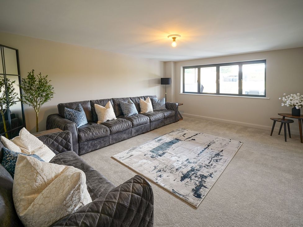 A living room with a sofa and a coffee table at Northstone House Blackburn