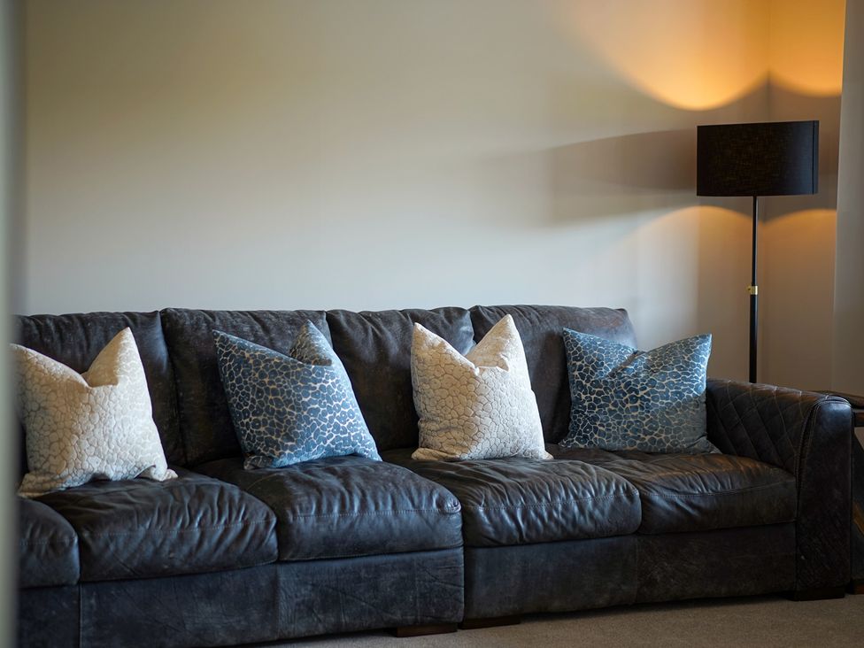 A living room with a sofa and cushions at Northstone House Blackburn