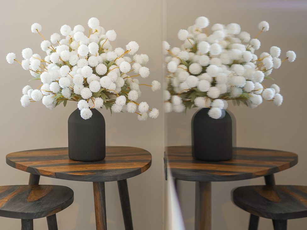 A table with a vase of flowers at Northstone House Blackburn