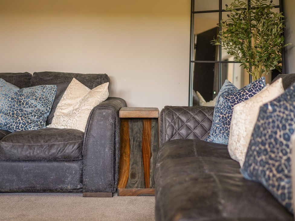 A living room with a sofa and side table at Northstone House Blackburn