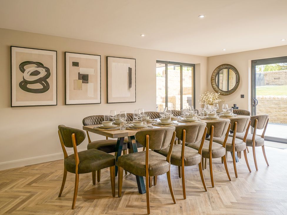 A dining room with a large table and chairs at Northstone House Blackburn