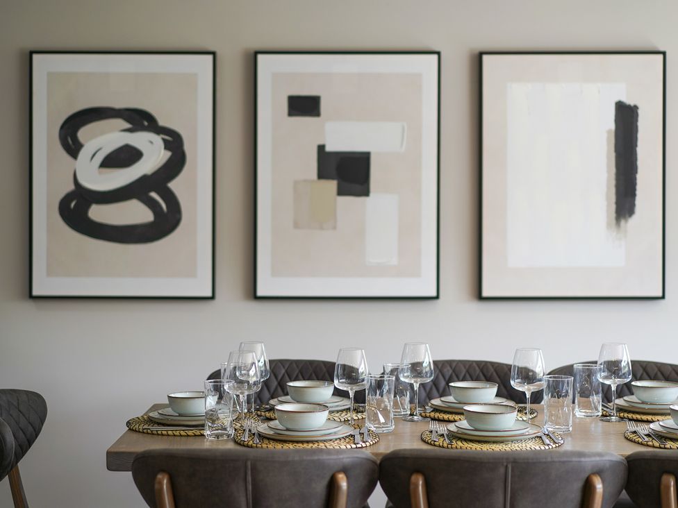 A dining table set with plates and glasses at Northstone House in Blackburn
