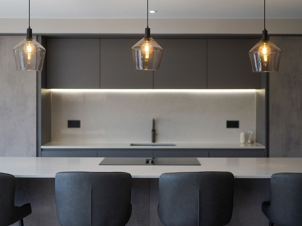 A kitchen with a countertop and pendant lights at Northstone House Blackburn