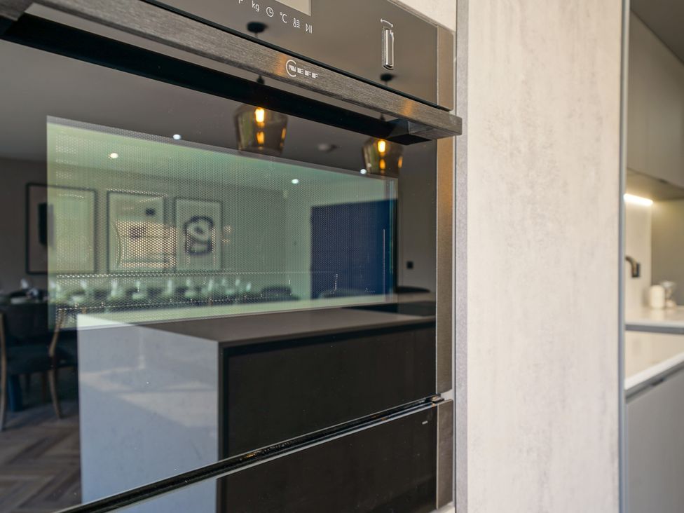 A kitchen with an oven and countertop at Northstone House Blackburn