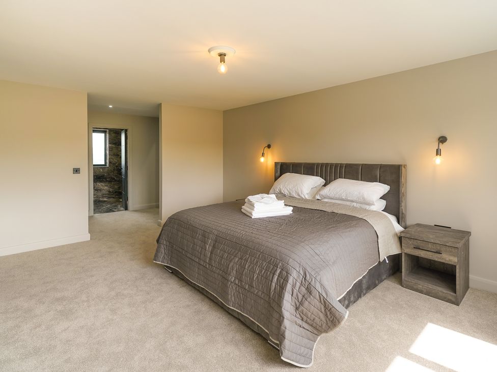 A bedroom with a bed and nightstand at Northstone House Blackburn