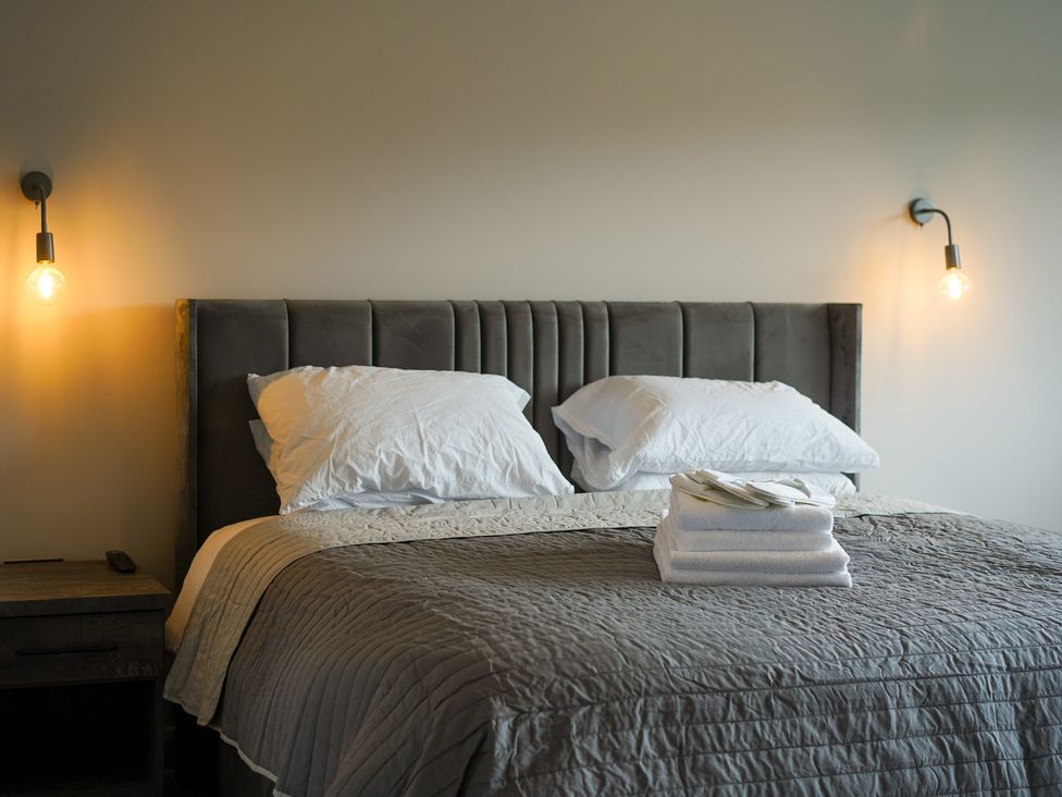 A bedroom with a bed and bedside table at Northstone House Blackburn