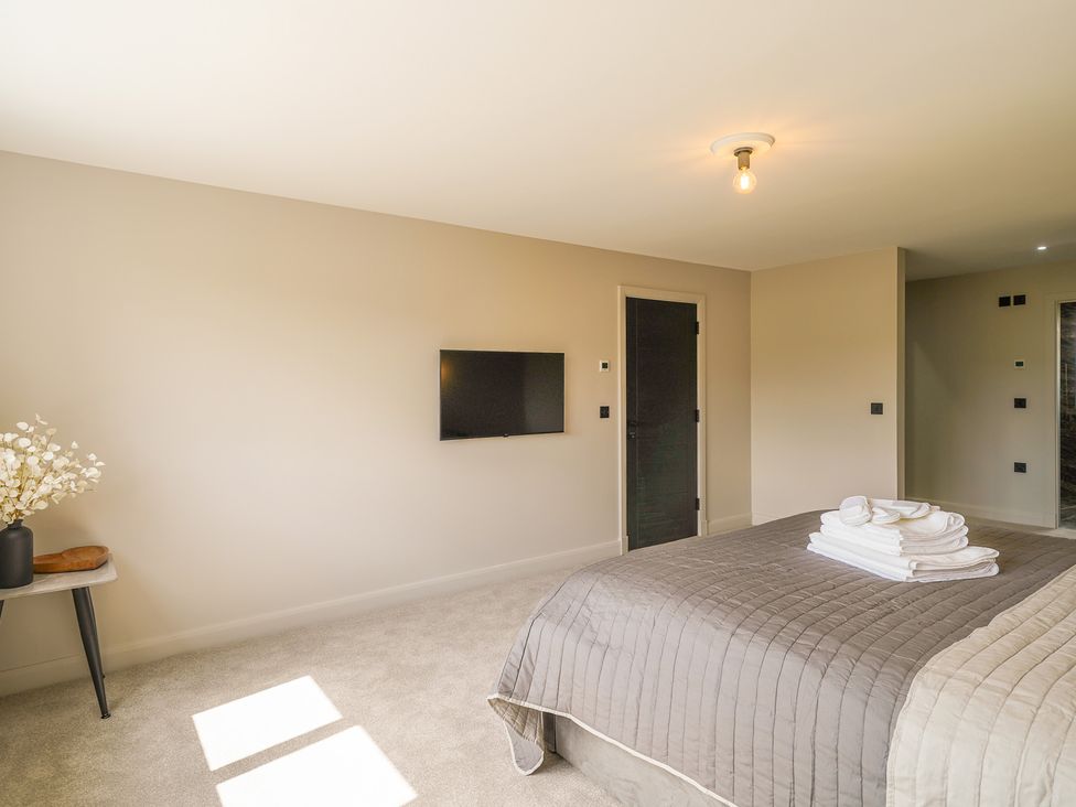 A bedroom with a bed and television at Northstone House Blackburn