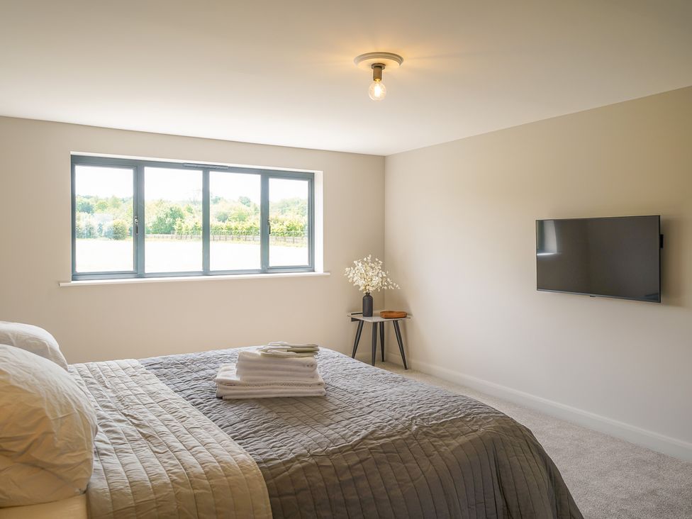 A bedroom with a bed and television at Northstone House in Blackburn