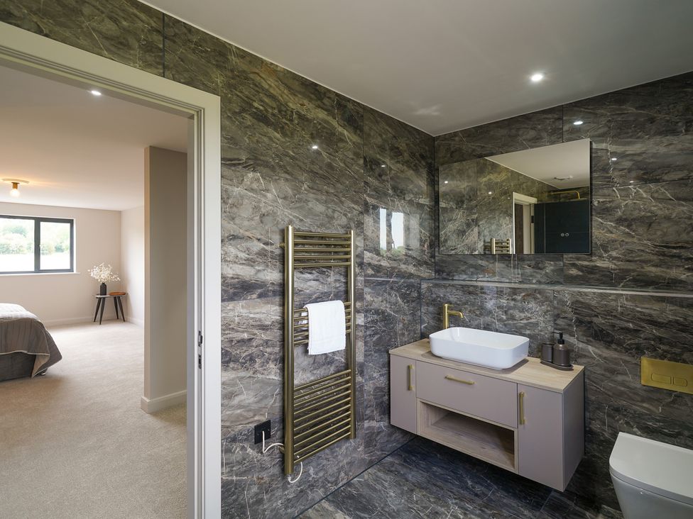 A bathroom with a sink and towel warmer at Northstone House in Blackburn