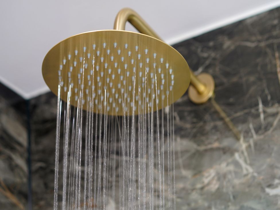 A showerhead with water flowing at Northstone House Blackburn