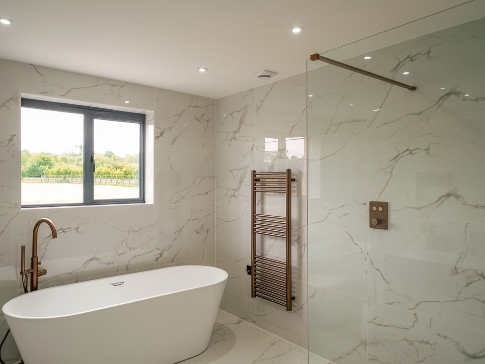 A bathroom featuring a bathtub and a shower at Northstone House Blackburn