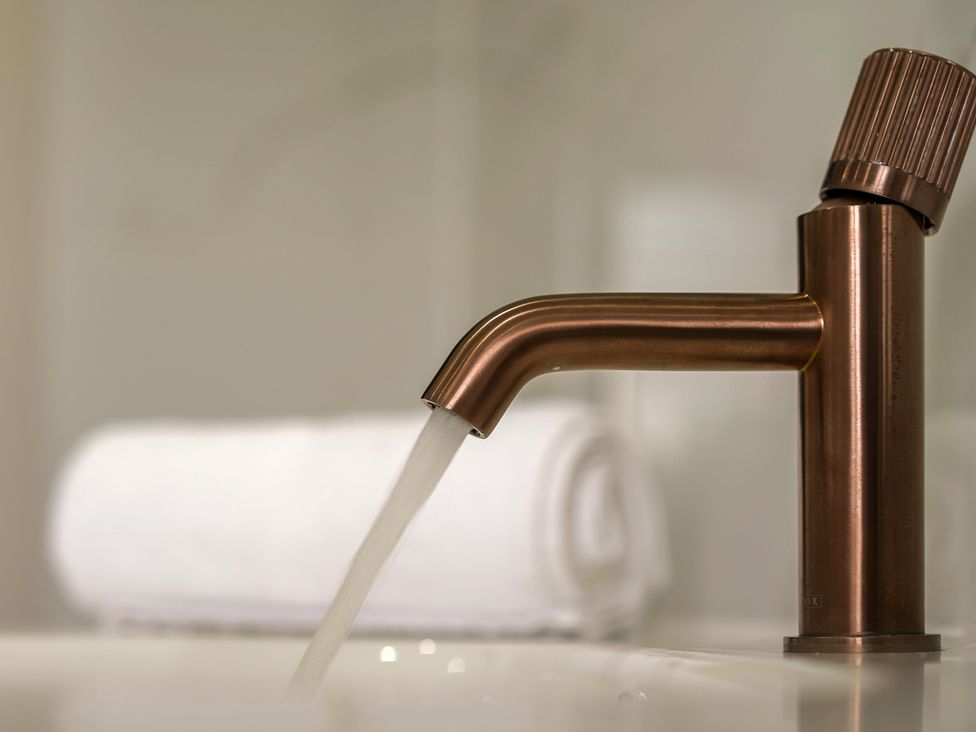 A faucet with water running at Northstone House Blackburn
