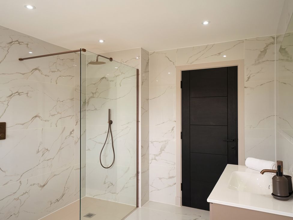 A bathroom featuring a shower and sink at Northstone House Blackburn