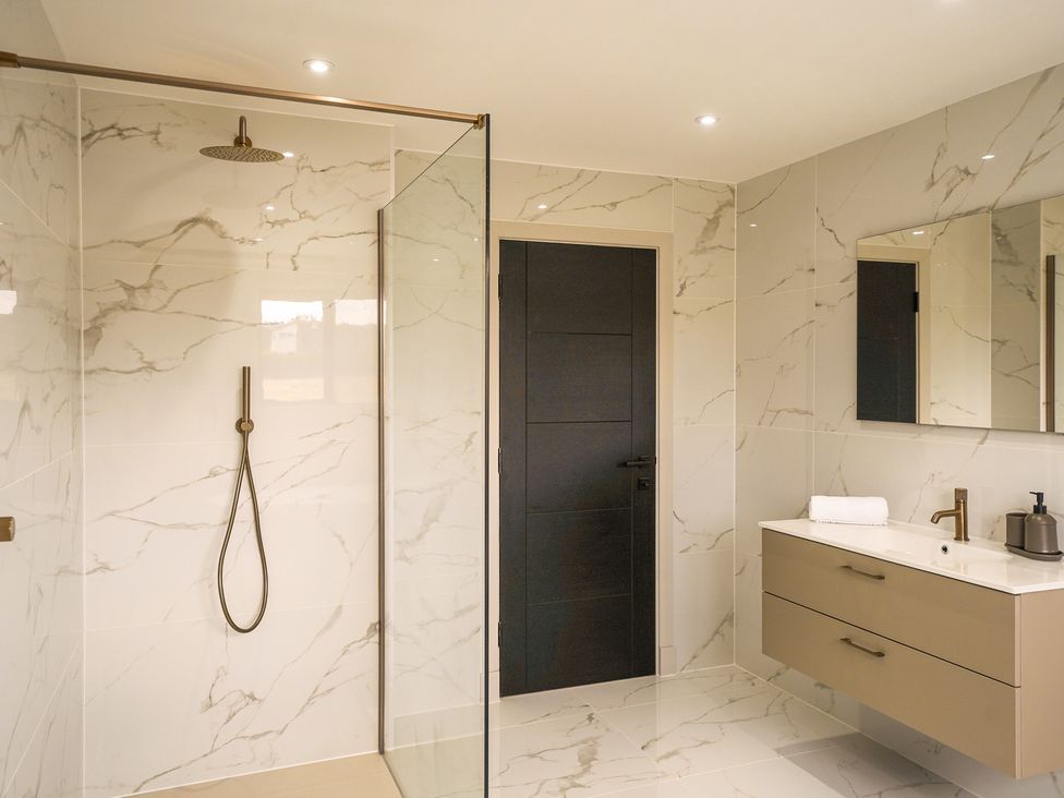 A bathroom with a shower and vanity unit at Northstone House Blackburn