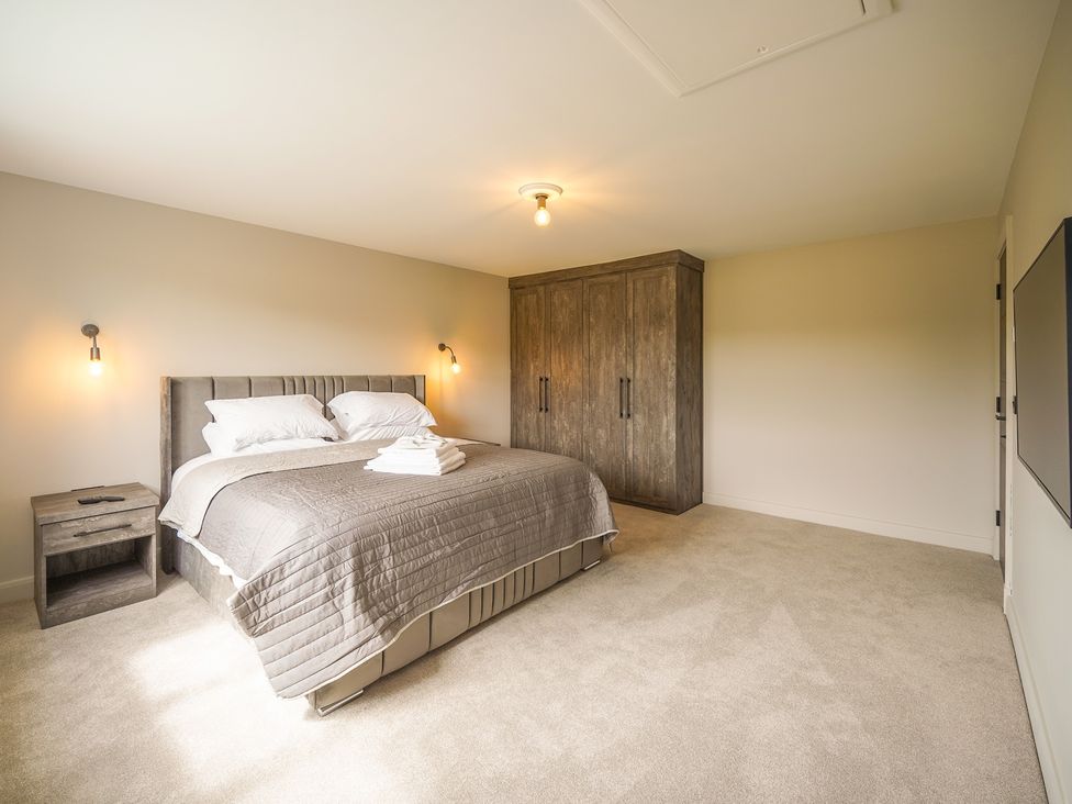A bedroom with a bed and wardrobe at Northstone House in Blackburn