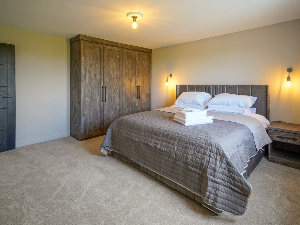 A bedroom with a bed and wardrobe at Northstone House Blackburn