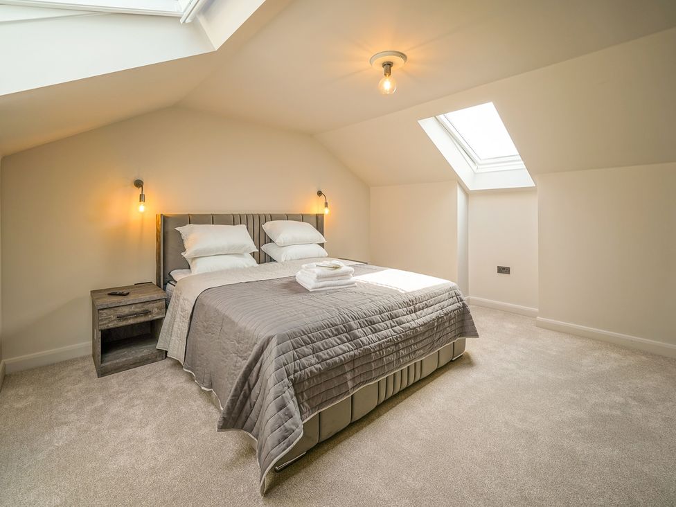 A bedroom with a bed and nightstand at Northstone House Blackburn