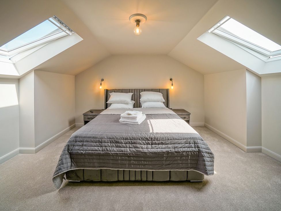 A bedroom with a bed and skylights at Northstone House Blackburn