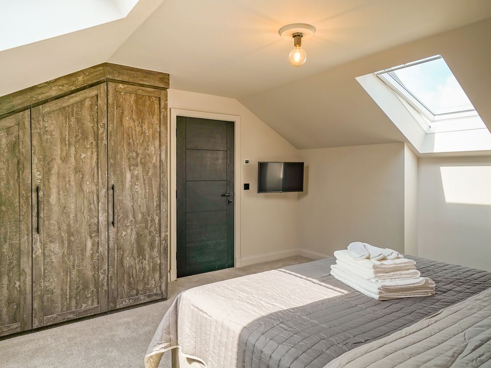 A bedroom with a wardrobe and television at Northstone House Blackburn