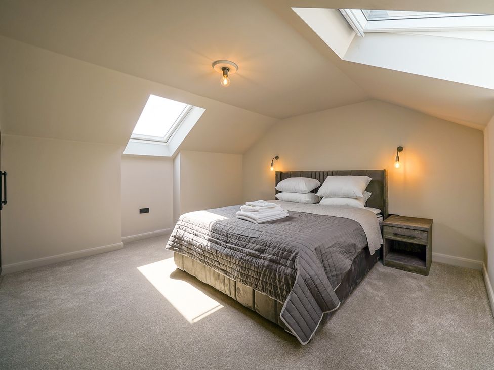 A bedroom with a bed and skylight at Northstone House Blackburn