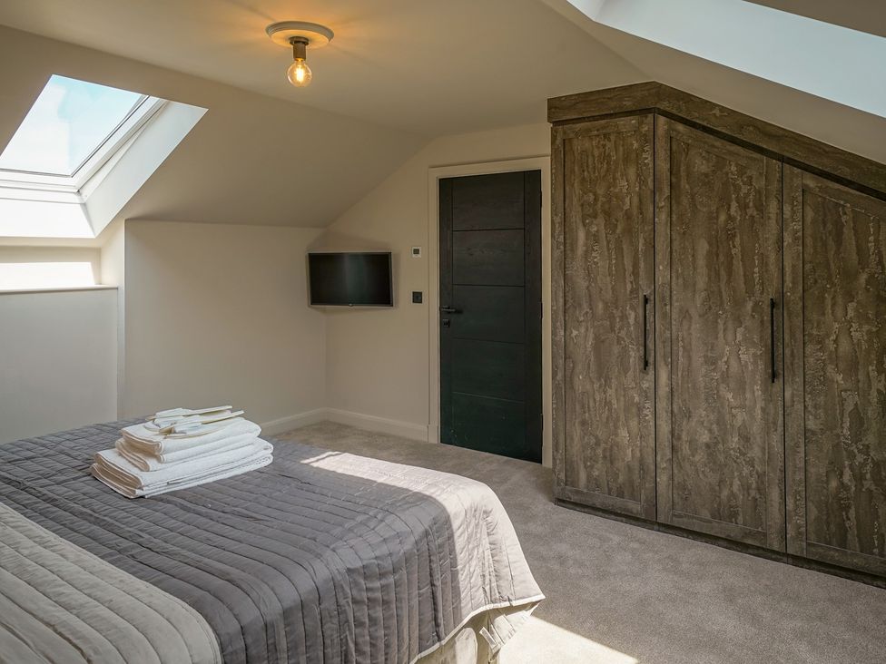 A bedroom with a bed and wardrobe at Northstone House Blackburn