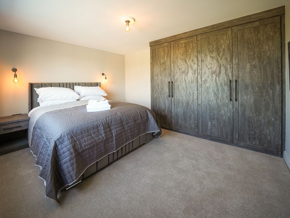 A bedroom with a bed and wardrobe at Northstone House Blackburn