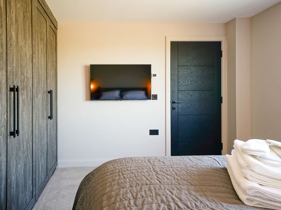 A bedroom with a wardrobe and a television at Northstone House Blackburn