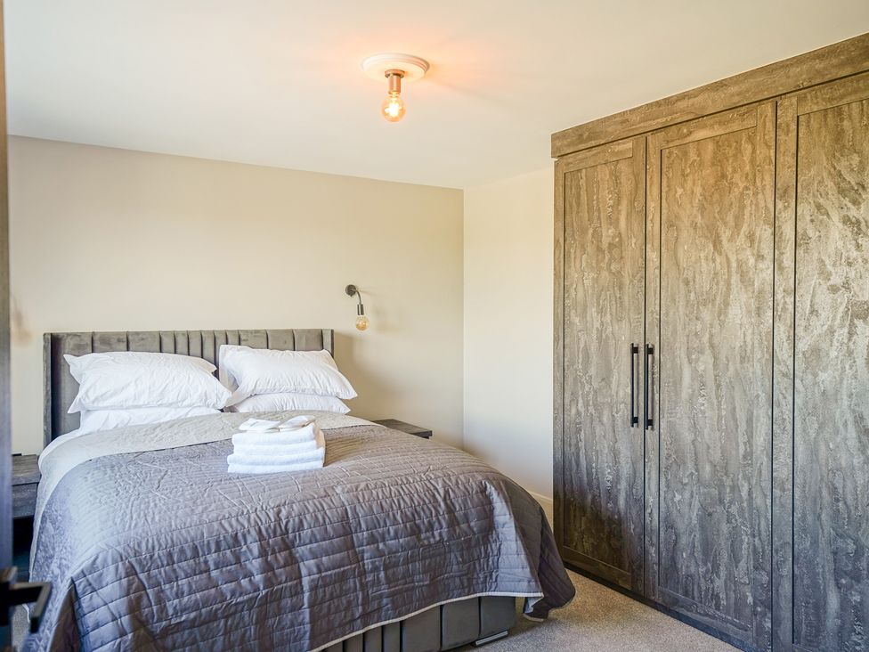 A bedroom with a bed and wardrobe at Northstone House Blackburn