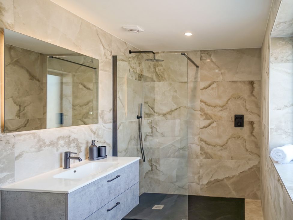 A bathroom with a shower and sink at Northstone House Blackburn