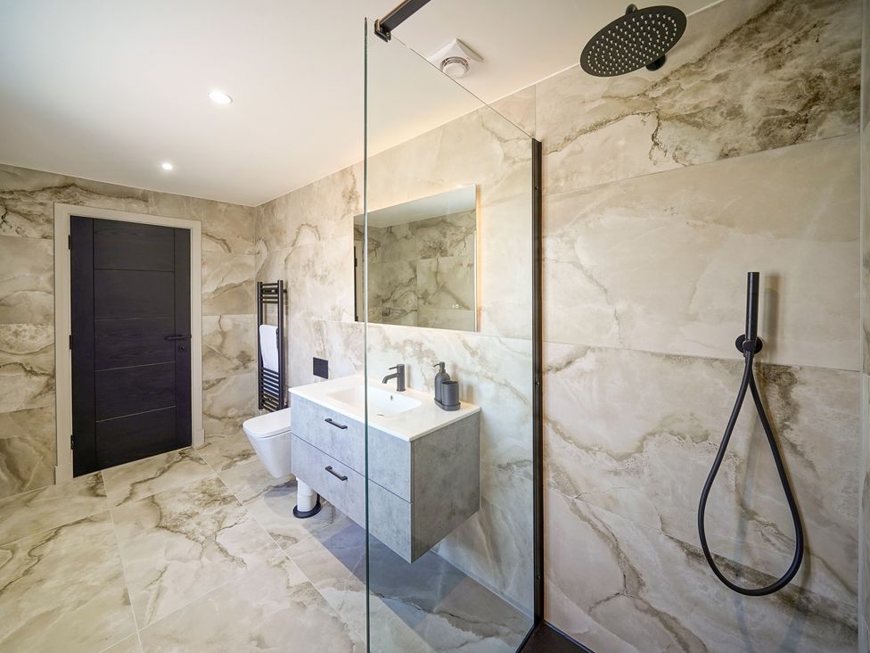 A bathroom with a shower and a vanity at Northstone House Blackburn