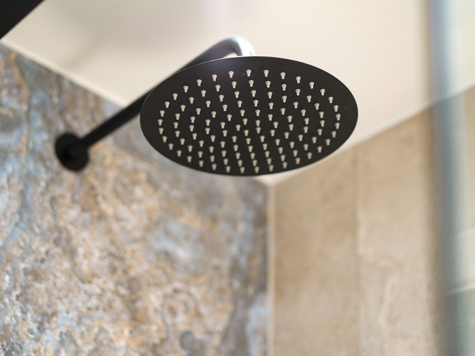 A shower head mounted on the wall at Northstone House Blackburn