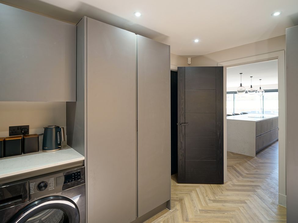 A laundry room with a washing machine and kettle at Northstone House Blackburn