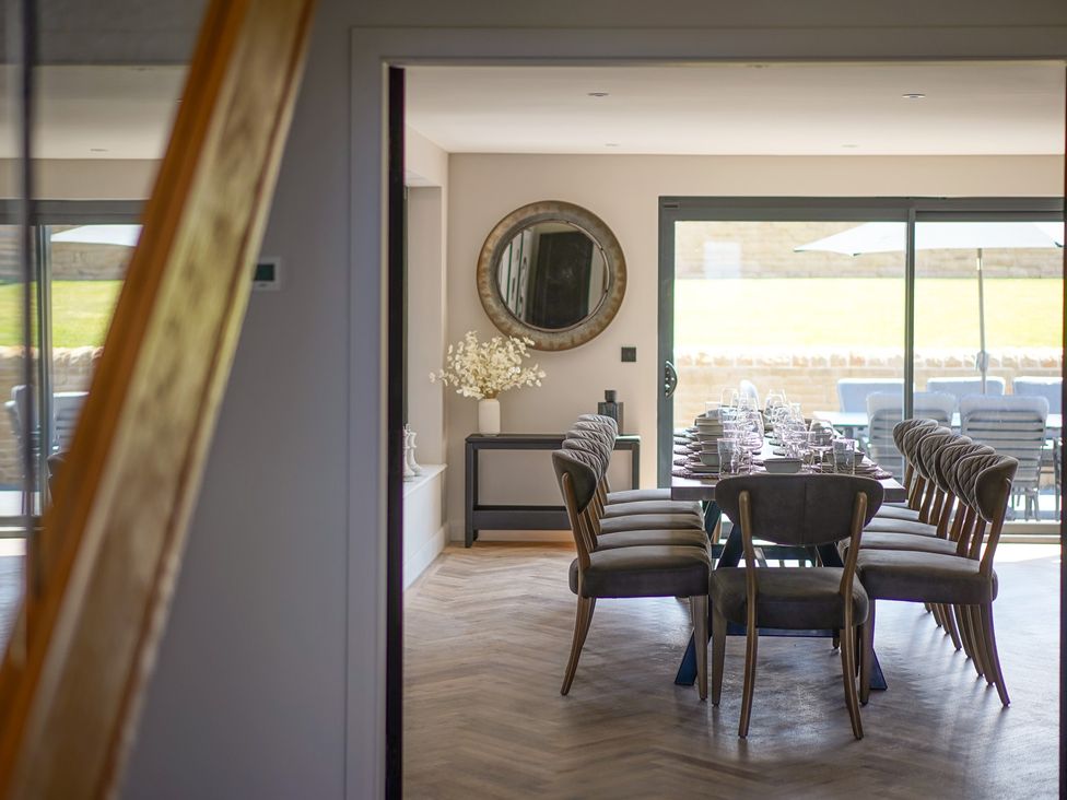 A dining room with a large table and chairs at Northstone House Blackburn