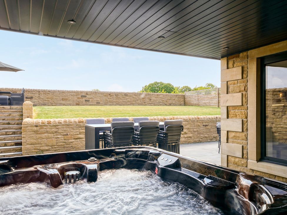 A hot tub with outdoor furniture at Northstone House Blackburn