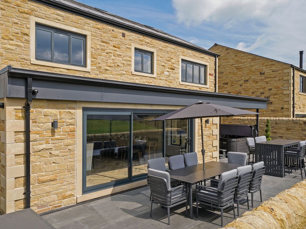 An outdoor dining area with a table and chairs at Northstone House Blackburn